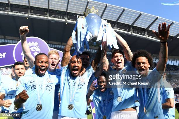 Fabian Delph of Manchester City lifts The Premier League Trophy after the Premier League match between Manchester City and Huddersfield Town at...