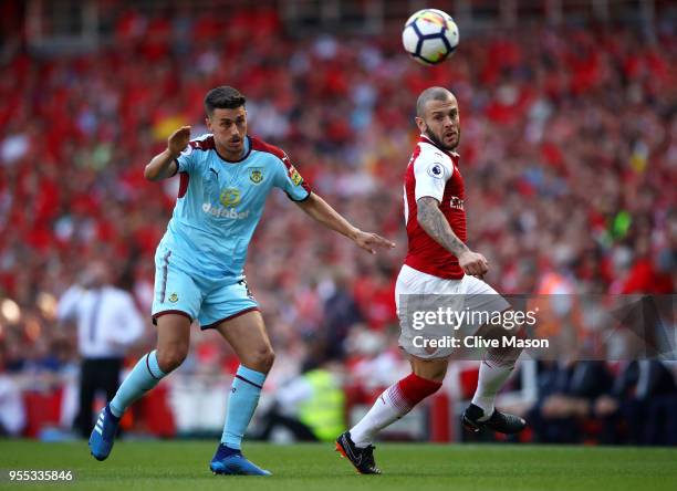 Jack Wilshere of Arsenal evades Matthew Lowton of Burnley during the Premier League match between Arsenal and Burnley at Emirates Stadium on May 6,...