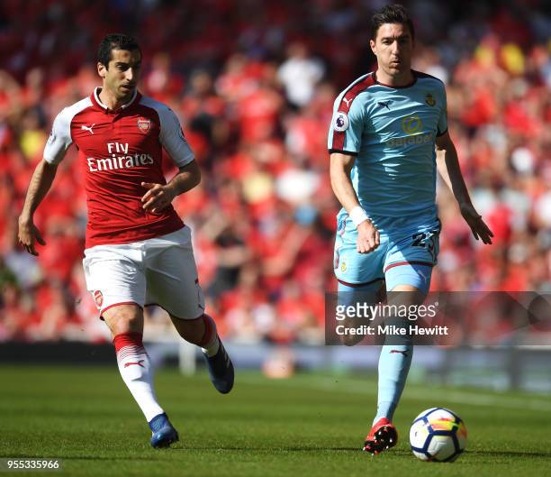 Henrikh Mkhitaryan of Arsenal looks on as Stephen Ward of Burnley runs with the ball during the Premier League match between Arsenal and Burnley at...