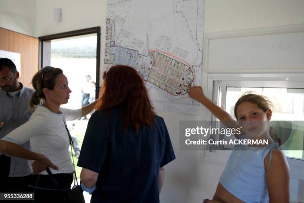 Northern Gaza settler families from Nissanit look at map for location of their new home before moving into the new settlement of Nitzan, just north...