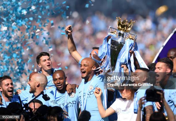 Vincent Kompany of Manchester City lifts the Premier League Trophy as Manchester City celebrate winning the Premier League after the Premier League...