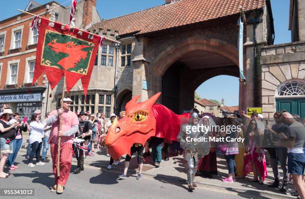 The red summer dragon, one of the two Glastonbury Dragons is paraded through the town as they take part in May Fayre and Dragon Procession in...