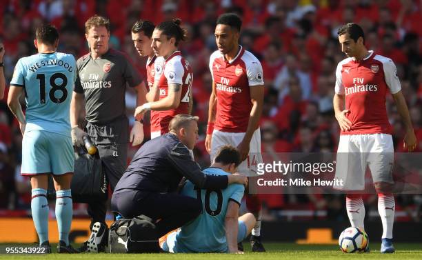 Ashley Barnes of Burnley receives treatment from the medical team during the Premier League match between Arsenal and Burnley at Emirates Stadium on...