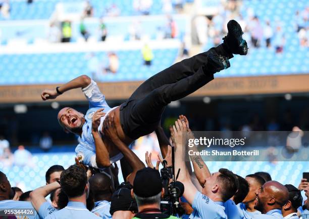 Josep Guardiola, Manager of Manchester City is thrown into the air as he and his team celebrate winning the premier league after the Premier League...