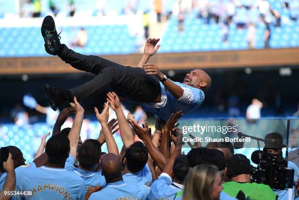 Josep Guardiola, Manager of Manchester City is thrown into the air as he and his team celebrate winning the premier league after the Premier League...