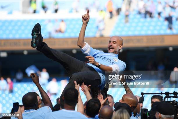 Josep Guardiola, Manager of Manchester City is thrown into the air as he and his team celebrate winning the premier league after the Premier League...