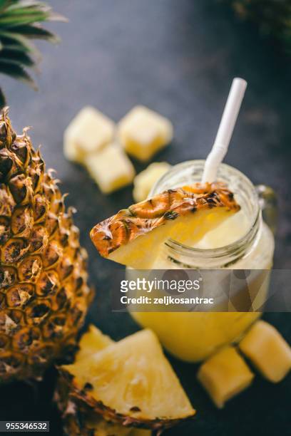 pineapple smoothie with fresh pineapple on wooden table - pineapple stock pictures, royalty-free photos & images