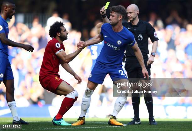 Mohamed Salah of Liverpool recieves a yellow card from match referee Anthony Taylor as Gary Cahill of Chelsea picks up Mohamed Salah of Liverpool...