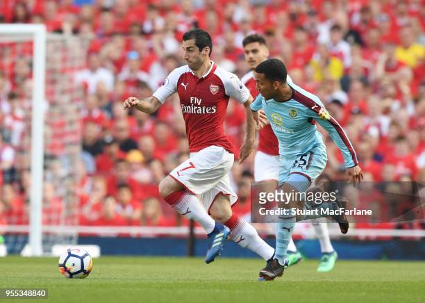 Henrikh Mkhitaryan of Arsenal breaks past Aaron Lennon of Burnley during the Premier League match between Arsenal and Burnley at Emirates Stadium on...
