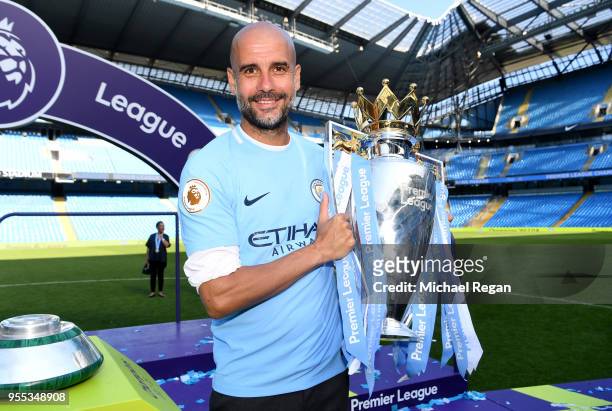 Josep Guardiola, Manager of Manchester City poses with The Premier League Trophy after the Premier League match between Manchester City and...