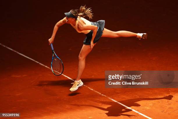 Maria Sharapova of Russia serves against Mihaela Buzarnescu of Romania in their first round match during day two of the Mutua Madrid Open tennis...