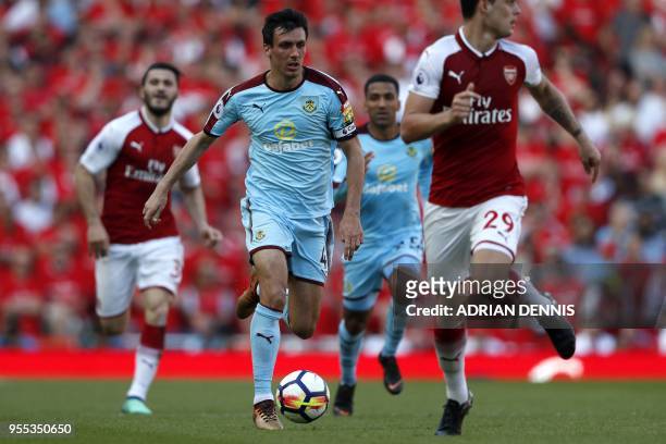 Burnley's English midfielder Jack Cork runs with the ball during the English Premier League football match between Arsenal and Burnley at the...