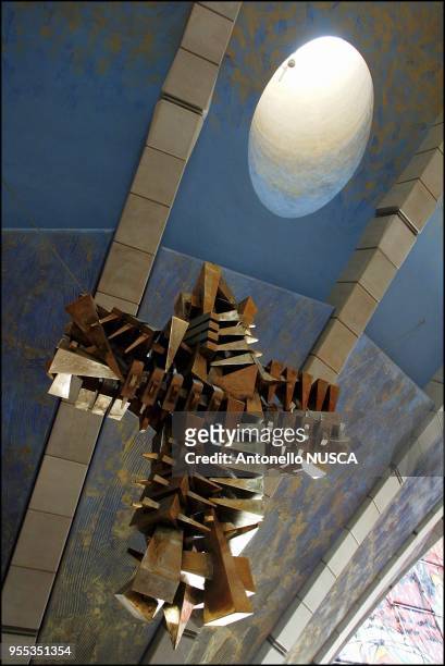 The cruucifix designed by Arnaldo Pomodoro above the altar of the massive new modern church designed by the self-confessed bad boy of European...