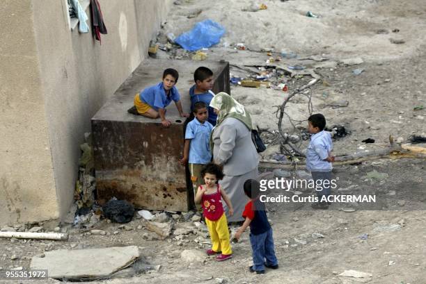 An Israeli Arab woman and children in the East Jerusalem village of Silwan on Saturday June 4, 2005. The Knesset will Wednesday debate an urgent...