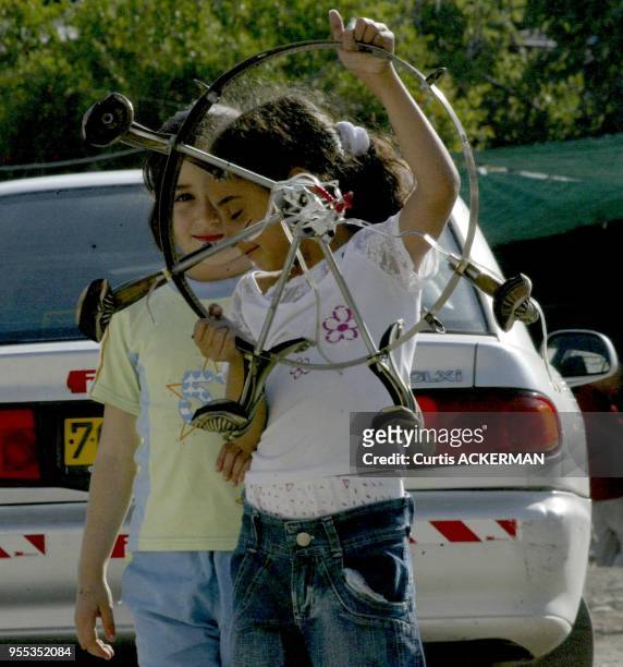 Two little Israeli Arab girls play in the East Jerusalem village of Silwan on Saturday June 4, 2005. The Knesset will Wednesday debate an urgent...