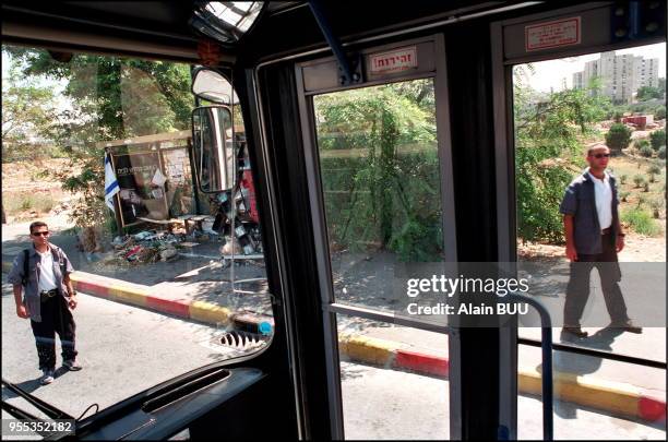 Bus n° 32A arriving near the scene of June 18th suicide bombing in which 19 people were killed and 74 injured. Two security officers are waiting to...