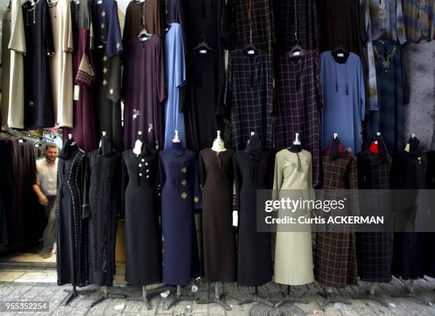 The traditional dresses of Muslim women hang outside on display in the Muslim Quarter of Jerusalem's Old City. The Muslim Quarter derives most of the...