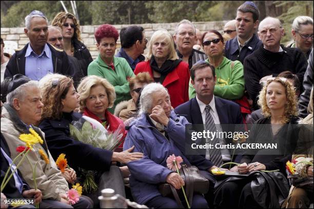 The late Prime Minister Yitzhak Rabin's sister, Rachel Ya'akov, surrounded by other family memebers and friends, wipes a tear at a grave site...