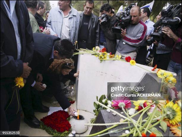 The late Prime Minister Yitzhak Rabin's daughter, Daliah lights a memorial candle, at a grave site memorial service in Jerusalem's Mt. Herzl cemetery...