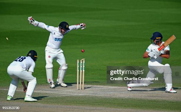 Max Holden of Middlesex looks on as he is bowled out as Ben Brown of Sussex celebrates during day three of the Specsavers County Championship:...