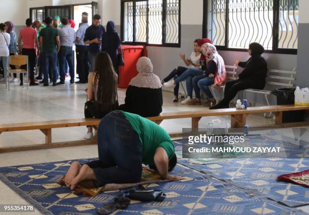 Lebanese Muslim man prays at a polling station in the city of Nabatieh in southern Lebanon on May 6 as the country votes in its first parliamentary...