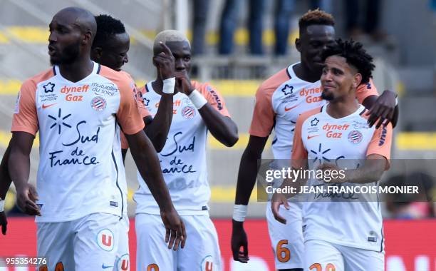 Montpellier's South African forward Keagan Dolly is congratulated by teammates after scoring a goal during the French L1 football match Nantes vs...