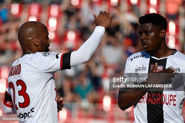 Guinguamp's Cameroonean defender Felix Eboa Eboa celebrates with teammates after scoring a goal during the French L1 football match between Dijon and...