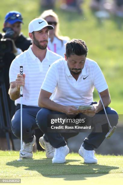 Mike Lorenzo-Vera of France and Romain Wattel of France line up a putt during the final match during day two of the GolfSixes at The Centurion Club...