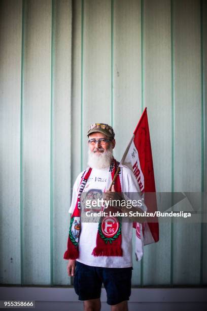 Fan of Duesseldorf poses with his flag prior to the Second Bundesliga match between Fortuna Duesseldorf and Holstein Kiel at Esprit-Arena on May 6,...