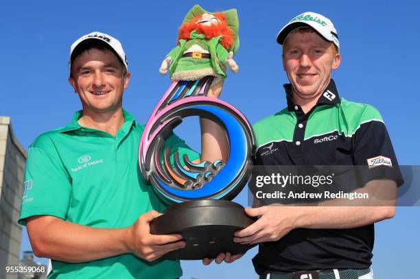 Paul Dunne and Gavin Moynihan of Ireland pose with the trophy following their victory during day two of the GolfSixes at The Centurion Club on May 6,...