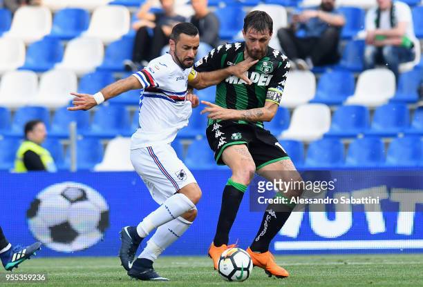 Fabio Quagliarella of UC Sampdoria competes for the ball whit Francesco Acerbi of US Sassuolo during the serie A match between US Sassuolo and UC...