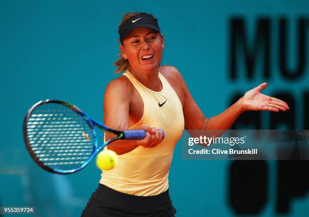 Maria Sharapova of Russia plays a forehand against Mihaela Buzarnescu of Romania in their first round match during day two of the Mutua Madrid Open...