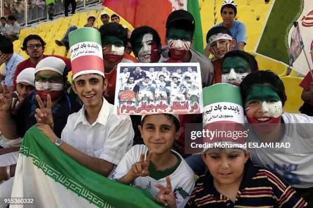 Iranian fans cheer during their National team's Group B Asian zone 2006 world cup qualifyer match against North Korea at the Azadi Stadium in Tehran....