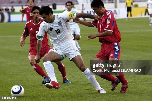 Ali Daei Cpitan of Iran's Team passing two North Korean defender fight for the ball during their Group B Asian zone 2006 World Cup qulifyer Match at...