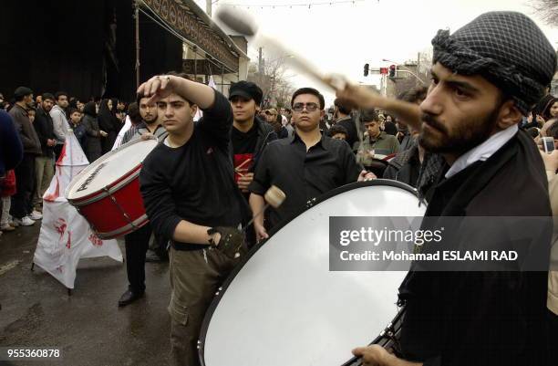 Iranian Muslims Shiites attend a ceremony to mark Ashura , the commemoration of the death of Imam Hussein , a grandson of Islam 's Prophet Mohammad ,...