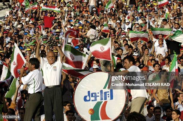 Iranian fans cheer during their National team's Group B Asian zone 2006 world cup qualifyer match against North Korea at the Azadi Stadium in Tehran....