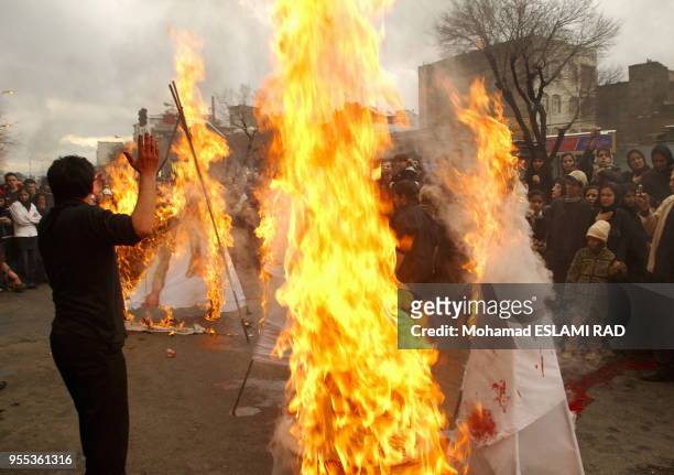 Iranian Muslims Shiites attend a ceremony to mark Ashura , the commemoration of the death of Imam Hussein , a grandson of Islam 's Prophet Mohammad ,...
