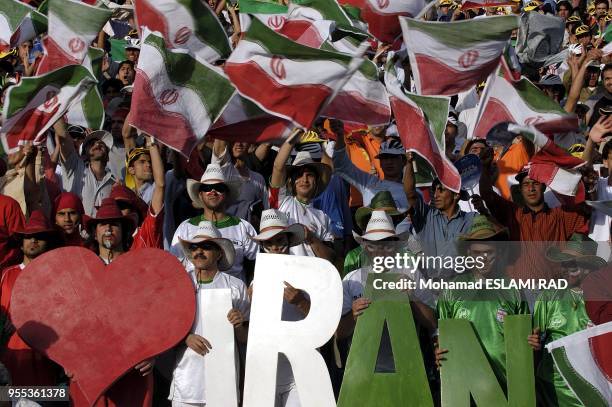 Iranian fans cheer during their National team's Group B Asian zone 2006 world cup qualifyer match against North Korea at the Azadi Stadium in Tehran....