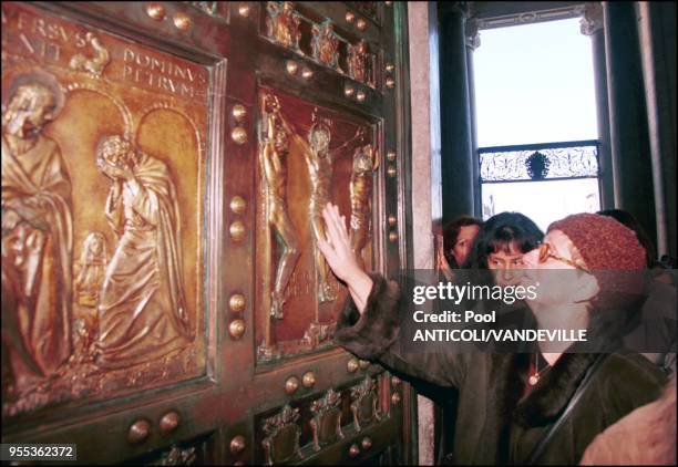 PEOPLE AT THE HOLY DOOR OF SANTA MARIA MAGGIORE BASILICA.