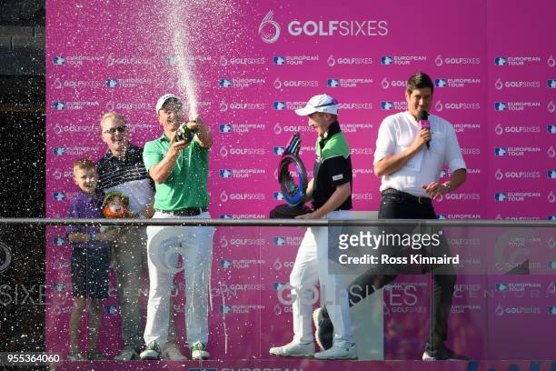 Paul Dunne and Gavin Moynihan of Ireland celebrate victory with champagne during day two of the GolfSixes at The Centurion Club on May 6, 2018 in St...