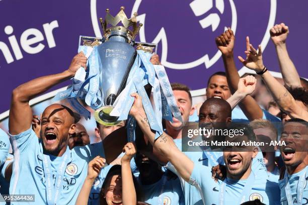 Vincent Kompany of Manchester City lifts the Premier League Trophy during the championship celebrations after the Premier League match between...