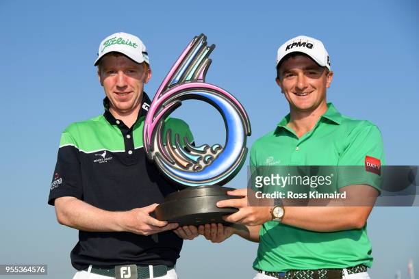 Paul Dunne and Gavin Moynihan of Ireland celebrate victory with the trophy during day two of the GolfSixes at The Centurion Club on May 6, 2018 in St...