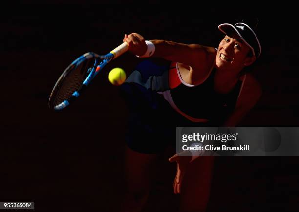Garbine Muguruza of Spain serves against Shuai Peng of China in their first round match during day two of the Mutua Madrid Open tennis tournament at...