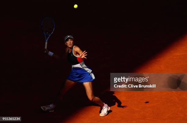 Garbine Muguruza of Spain looks up at a high ball as she gets ready to play a forehand against Shuai Peng of China in their first round match during...