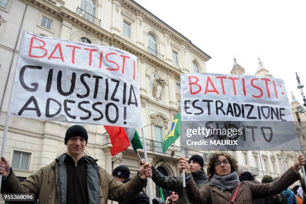 Demonstrators hold placards reading: 'Battisti extradition now','Battisti:Justice now','Italy wants justice. Battisti, extradition now' during a...