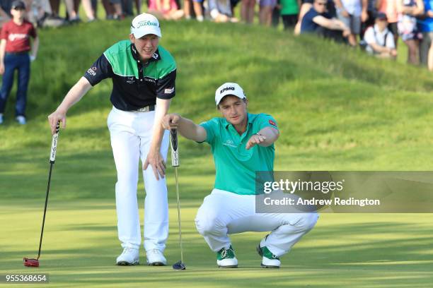 Paul Dunne and Gavin Moynihan of Ireland line up a putt during the final match during day two of the GolfSixes at The Centurion Club on May 6, 2018...