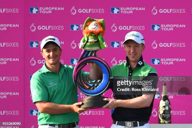 Paul Dunne and Gavin Moynihan of Ireland celebrate victory with the trophy during day two of the GolfSixes at The Centurion Club on May 6, 2018 in St...