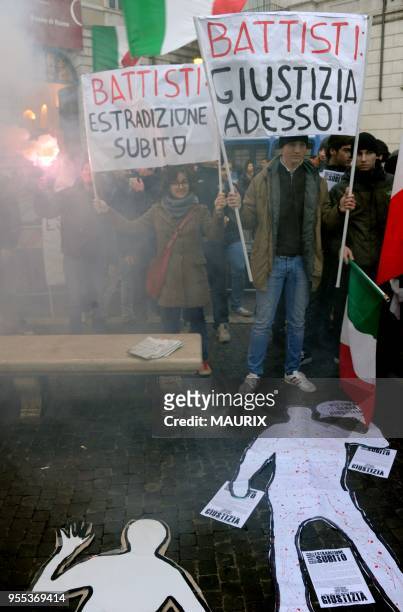 Demonstrators hold placards reading: 'Battisti extradition now','Battisti:Justice now','Italy wants justice. Battisti, extradition now' during a...