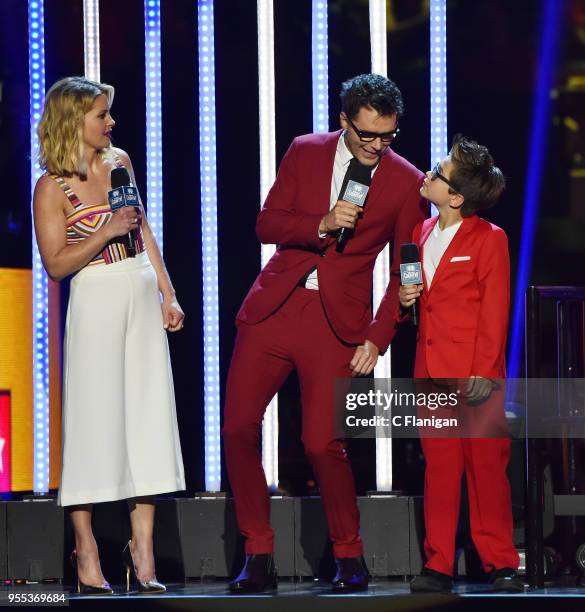 Hosts Candace Cameron-Bure, Bobby Bones and mini Bobby Bones speak onstage during the 2018 iHeartCountry Festival by AT&T at The Frank Erwin Center...