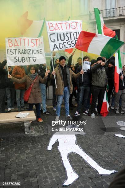 Demonstrators hold placards reading: 'Battisti extradition now','Battisti:Justice now','Italy wants justice. Battisti, extradition now' during a...